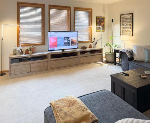a living room with a large flat screen tv at A quiet, stylish and cozy retreat. in Page