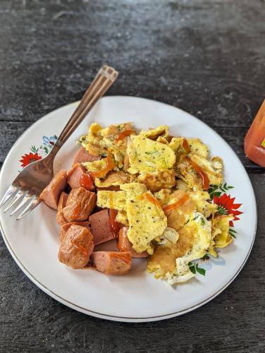 a plate of food with scrambled eggs and potatoes at Villa 163 in Negombo