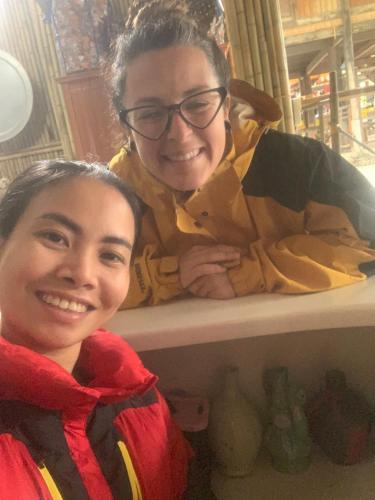 two young girls are sitting on a shelf at Mai chau Horizon Homestay in Mai Chau