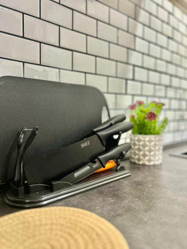 a pair of scissors sitting on top of a counter at 2024 Newly Renovated Modern&Spacious 17pax Semi-D in Alor Setar