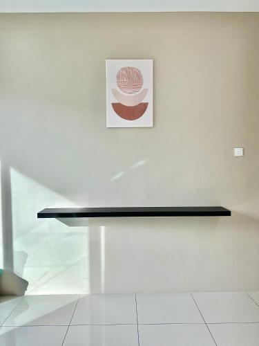 a black shelf on a white wall with a picture at 2024 Newly Renovated Modern&Spacious 17pax Semi-D in Alor Setar