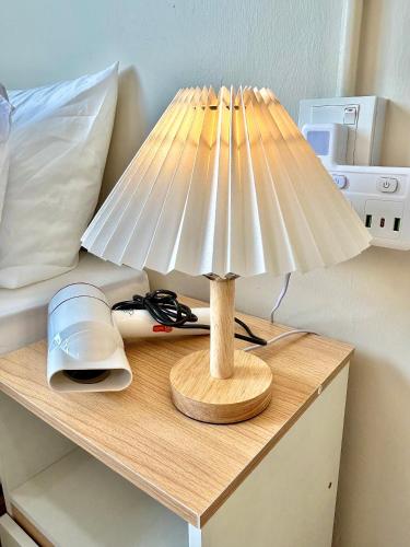 a table with a lamp on top of a bed at 2024 Newly Renovated Modern&Spacious 17pax Semi-D in Alor Setar