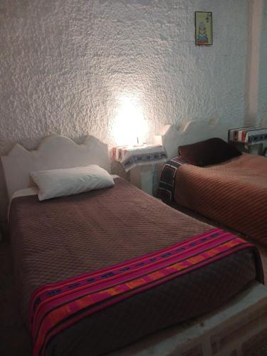 two beds sitting next to each other in a room at Beds of salt G in Potosí