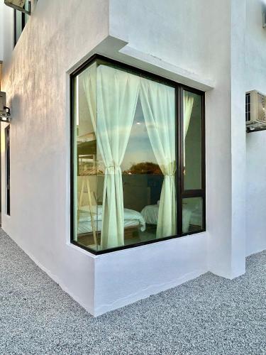 a room with a window with a bed in it at 2024 Newly Renovated Modern&Spacious 17pax Semi-D in Alor Setar