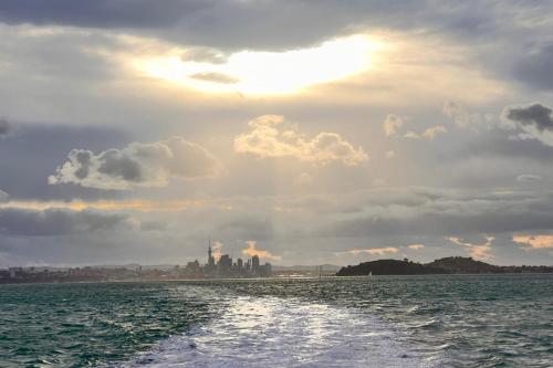 a view of a city from a boat in the water at Waiheke Backpackers Hostel in Onetangi