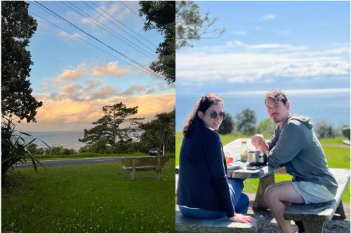 a man and a woman sitting at a picnic table at Waiheke Backpackers Hostel in Onetangi