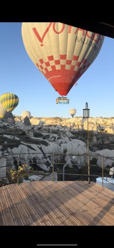 a group of hot air balloons flying in the sky at Naraca Cave House in Goreme