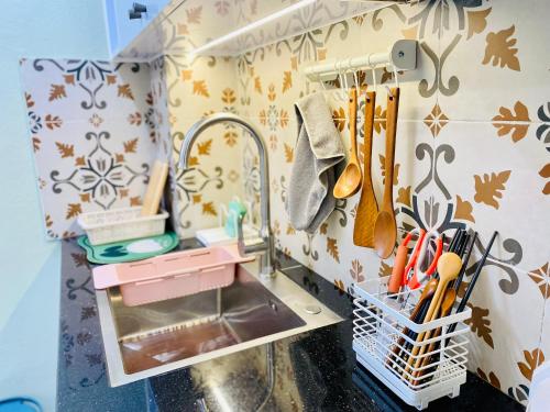 a miniature kitchen with a sink and utensils at G-space apartment in Hai Phong