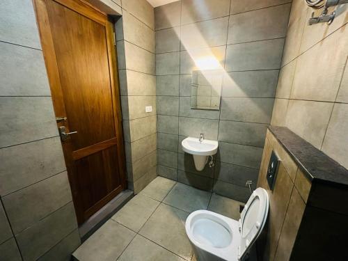 a bathroom with a toilet and a sink at Mary Land Residency in Meenangadi