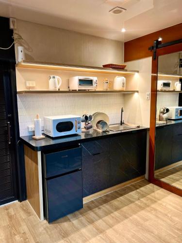 a kitchen with a counter with a microwave on it at Cozy Tiny Home with Outdoor Hot Tub in City Center in Davao City