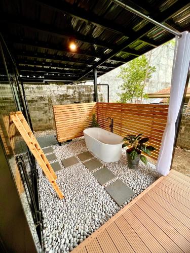 a bathroom with a bath tub on a patio at Cozy Tiny Home with Outdoor Hot Tub in City Center in Davao City