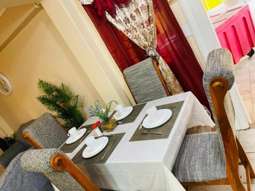 a dining table and chairs with a christmas tree on it at Destination Hope Booking in Georgetown