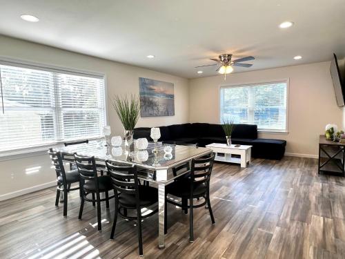 a living room with a table and chairs and a couch at Beach House Cape May just 1 block from the Bay & a Short 5 minutes walk, Sleeps 19 in Cape May