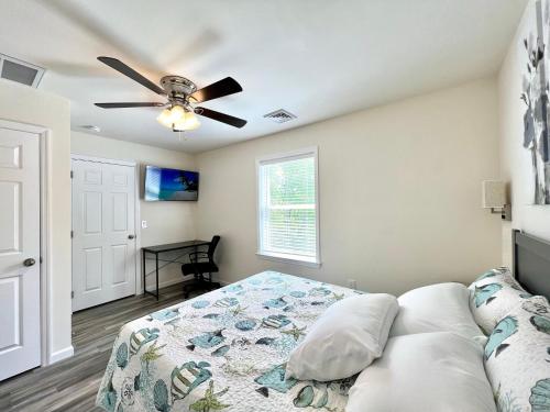 a bedroom with a bed and a ceiling fan at Beach House Cape May just 1 block from the Bay & a Short 5 minutes walk, Sleeps 19 in Cape May
