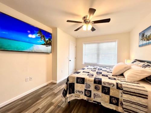a bedroom with a bed and a ceiling fan at Beach House Cape May just 1 block from the Bay & a Short 5 minutes walk, Sleeps 19 in Cape May
