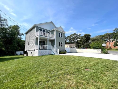 a house with a large yard in front of it at Beach House Cape May just 1 block from the Bay & a Short 5 minutes walk, Sleeps 19 in Cape May