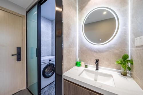 a bathroom with a sink and a washing machine at Yozo Serviced Apartment in Shanghai