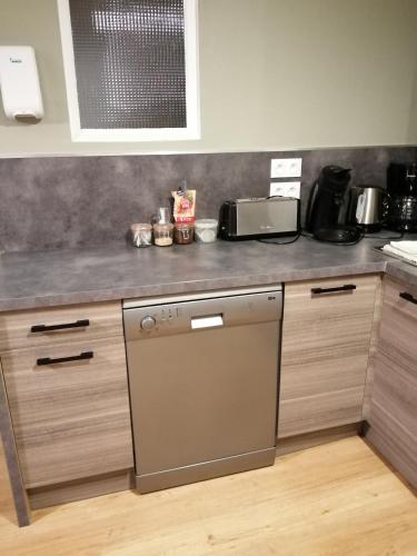a kitchen with a counter top with a dishwasher at Chez Isa et Christophe in Mogeville