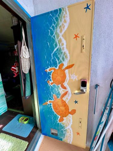 a childrens play room with a sea turtle painted on the door at Happy Island Miyako in Miyako Island