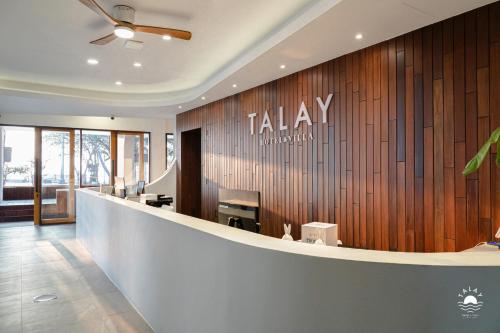 a view of a lobby with a takeaway sign on a wall at Talay Hotel and Villa Cha-am in Cha Am