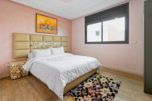 a bedroom with a large bed and a window at Imsouane Bay 2 Bedroom Suite Ocean View Terrace in Imsouane