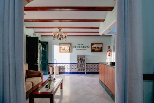 a living room with a couch and a table at Hotel Chamizo in El Arahal