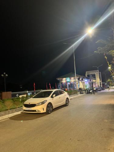 a white car parked on a street at night at Cao Bằng Siu homestay in Hoàng Ngà
