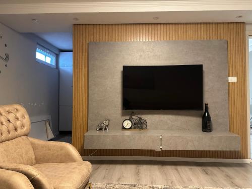 a living room with a flat screen tv on a wall at Skyline Apartment 2 in Peje