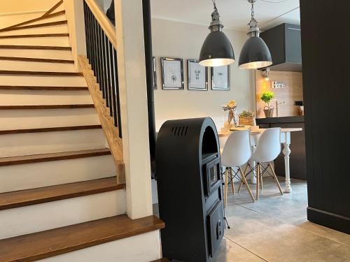 a living room with a staircase with a trash can at Gästewohnung am See in Neuenkirchen