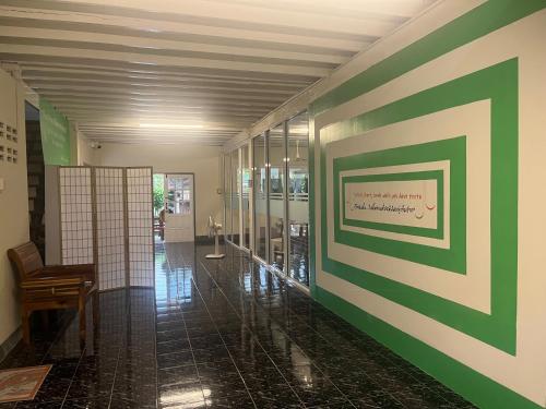 a hallway with a green and white wall at At Home Phetchaboon in Phetchabun