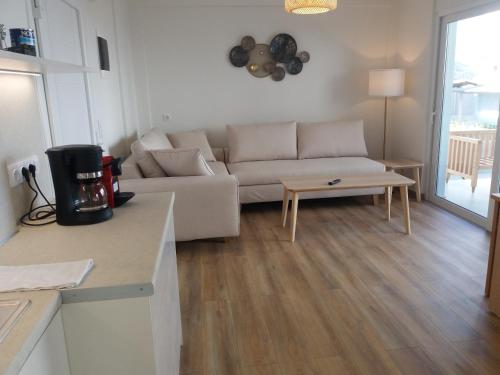 a living room with a couch and a table at Stavento in Diakopto