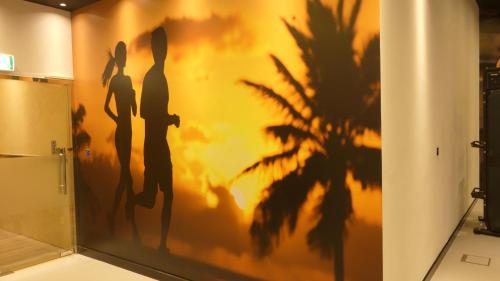 a wall with silhouettes of women on it at Stargazers cozy apartment with direct Metro access in Dubai