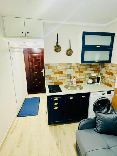 a small kitchen with a sink and a stove at Suite4Rent Iași in Iaşi