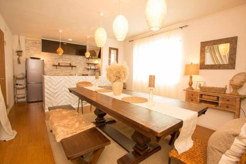 a dining room with a table and a kitchen at ライカムまで10分!!大人女子にオススメ。フォトジェニックなアンティーク家具に囲まれて最高の夜を。。 in Awase