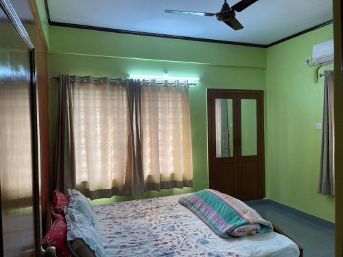 a bedroom with a bed and a ceiling fan at South-East-West Facing 3 BHK Lakeview Flat Howrah West Bengal in Howrah