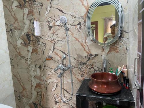 a bathroom with a copper sink and a mirror at South-East-West Facing 3 BHK Lakeview Flat Howrah West Bengal in Howrah