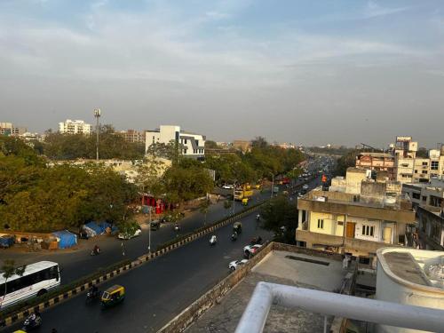 a view of a city street with a bus at Hotel Apple Inn in Ahmedabad