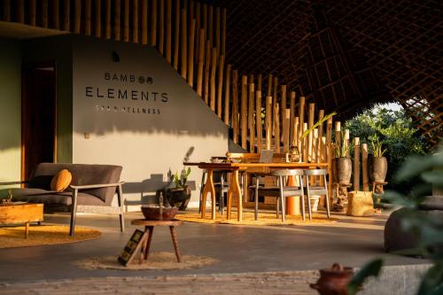 a building with a table and chairs in a room at Bamboo Zanzibar in Jambiani