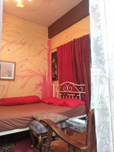 a bedroom with a bed with red curtains at GN GOOD NICE in Bangkok
