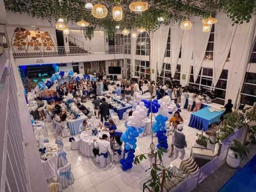 a group of people sitting at tables in a banquet hall at ROCCA Del GARDA Residences in Binangonan