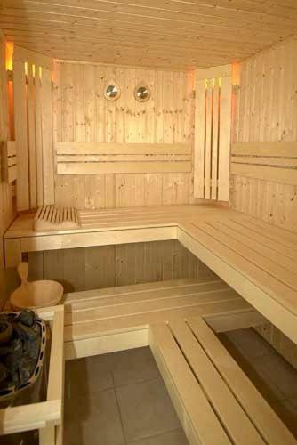 a sauna with a bench in the middle of a room at Romeos Hotel Luzira Kampala in Kampala