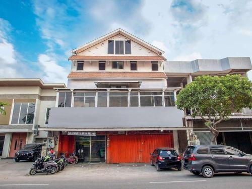 a building with cars parked in front of it at Angs residence in Surabaya