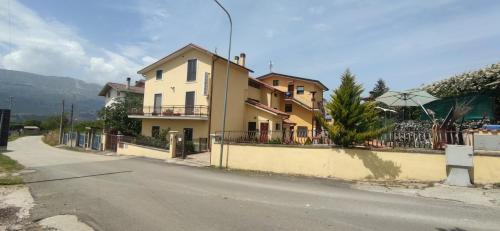 a house on the side of a street with a fence at Complesso turistico Aurora - Appartamenti in Poggio Picenze
