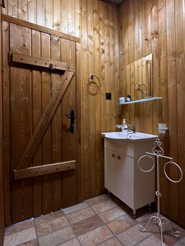 a bathroom with a wooden door and a sink at Oasis Blue Lozenets in Lozenets