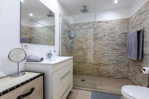 a bathroom with a sink and a shower at Ocean View Apartment with large terrace and Netflix smart TV Costa Adeje in Adeje