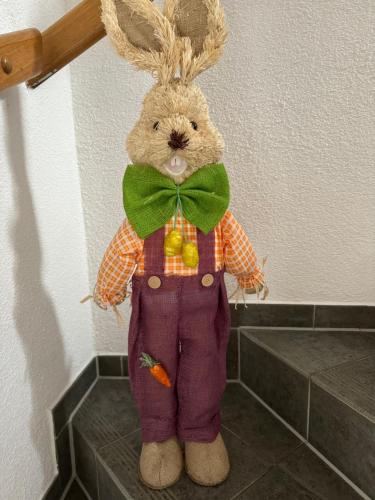 a stuffed rabbit with a bow tie and carrots on it at Goldene Krone in Belgershain