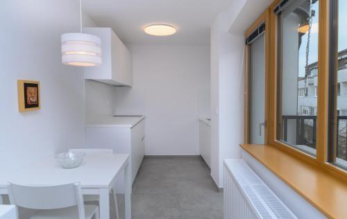 a kitchen with a white table and a window at Primus apartments in Ljubljana