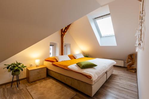 a bedroom with a bed with an attic at RASL Residens in Jihlava