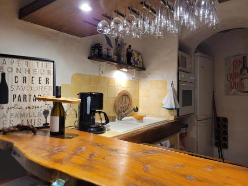a kitchen with a counter with a coffee maker on it at Maison In Vino in Nyons