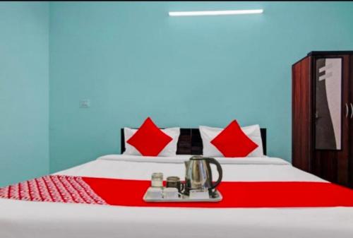 a bed with red pillows and a blender on it at MOHAN VILLA in New Delhi